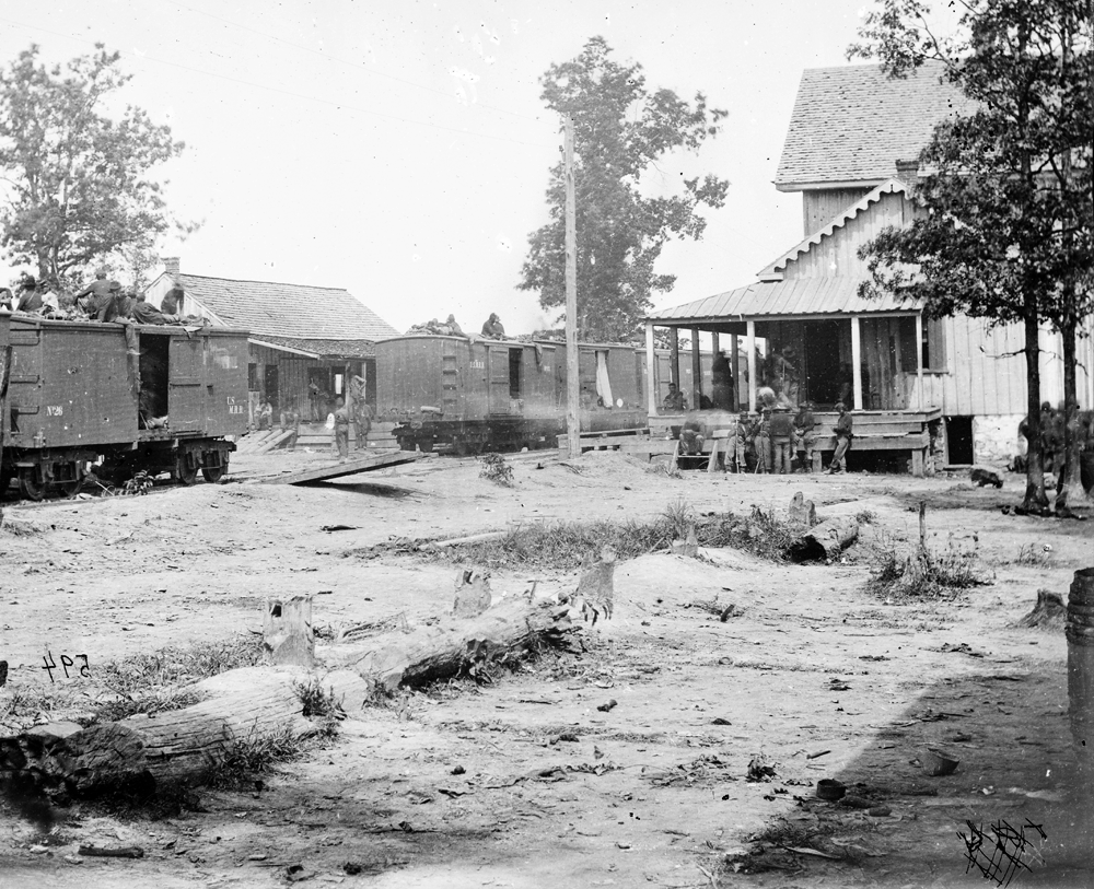 Photograph of the railroad station at Catlett's Station, Virginia with U.S. military railroad boxcars and soldiers